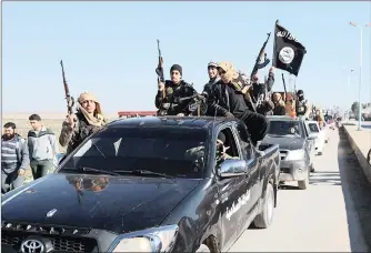  ?? | AP/AFRICAN NEWS AGENCY (ANA) ?? ISLAMIC State militants pass by a convoy in Tel Abyad, north-east Syria.