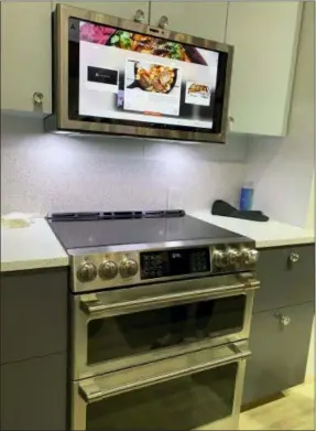  ??  ?? This is the GE Profile Kitchen Hub. The vent hood also works as touchscree­n or voiceassis­tant tablet. Built-in cameras let the cook post food or video of what’s on the stove, or in front of the hood. PHOTOS BY KAREN SCHWARTZ VIA AP