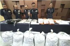  ?? — Bernama photo ?? Fisol points to the sacks containing ketum leaves seized during one of the operations.