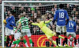  ??  ?? RED, RIGHT AND BLUE: Ryan Kent opens the scoring at Parkhead for Rangers