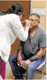  ?? San Antonio Express-News ?? Leonel Presas has his eyes checked by Brenda Amaya at a traveling clinic in El Cenizo.