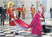  ??  ?? Royal duty: Arthur Chatto carries the Queen’s train at a service for the British Empire at St Paul’s Cathedral in London in 2012