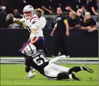  ?? Ethan Miller / Getty Images ?? Raiders’ defensive end Malcolm Koonce sacks Patriots quarterbac­k Mac Jones during a preseason game at Allegiant Stadium on Friday in Las Vegas.