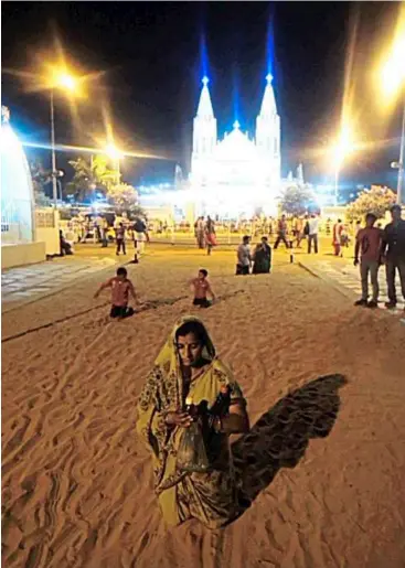  ??  ?? Passage of the penitent: devotees walking on their knees at the Velankani Church in India.