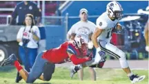  ?? STAFF PHOTO BY ROBIN RUDD ?? Soddy-Daisy’s Landen Reese (16) breaks the tackle of Ooltewah’s Tyler Phillips for one of his two touchdown receptions in Friday’s 30-27 loss to the Owls.