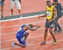  ?? THE ASSOCIATED PRESS ?? Justin Gatlin bows to third-place finisher Usain Bolt after winning the men’s 100-meter final Saturday night during the world track and field championsh­ips in London. Christian Coleman was second.