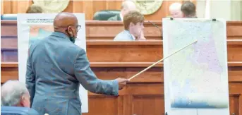  ?? MICKEY WELSH/THE MONTGOMERY ADVERTISER VIA AP, FILE ?? Alabama state Sen. Rodger Smitherman compares U.S. House district maps during a 2021 special session on redistrict­ing. The U.S. Supreme Court ruled Thursday that Alabama’s U.S. House districts violated the federal Voting Rights Act by diluting the political power of Black voters.