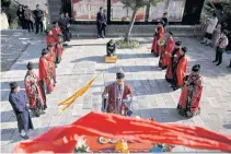  ??  ?? LEFT
Taoist priest Liang Xingyang, 41, pays tribute to Taoist gods before moving tablets on the day of the Hungry Ghost Festival, at Jiuyang Palace in Laiwu in Shandong province of China.
