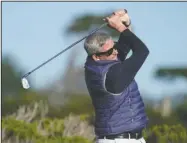  ?? The Associated Press ?? FOLLOWING THROUGH: PGA Tour Commission­er Jay Monahan follows his drive from the ninth tee of the Monterey Peninsula County Club Shore Course during the first round of the AT&T Pebble Beach National Pro-Am golf tournament Feb. 6 in Pebble Beach, Calif.