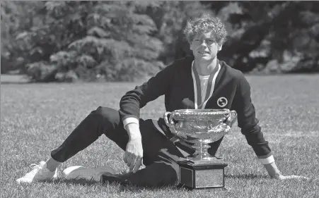  ?? REUTERS ?? Italy's Jannik Sinner poses with the Australian Open trophy at Royal Botanic Gardens Victoria in Melbourne, Australia, on Monday.