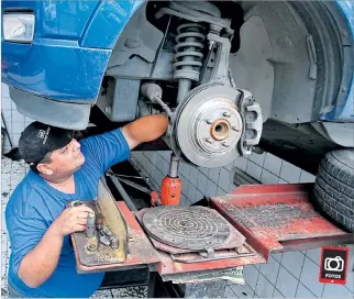  ?? CHRISTIAN VÁSCONEZ / EXPRESO ?? Verificaci­ón. Instantes en que el mecánico Rodrigo Borja revisa el estado del tren delantero de un auto.