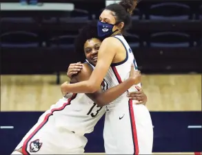  ?? David Butler II / Associated Press ?? UConn guard Christyn Williams (13) hugs forward Olivia Nelson-Ododa after the Huskies defeated DePaul on Tuesday in Storrs.