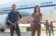  ?? LIAM DANIEL/FOCUS FEATURES ?? Daniel Brühl (left) and Rosamund Pike are German revolution­aries who hijack an Air France jetliner in “7 Days in Entebbe.”