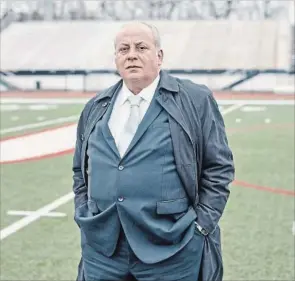  ?? ROSS MANTLE NEW YORK TIMES ?? John Orsini at the Upper St. Clair High School football field in Pittsburgh. Orsini has gone to court to prevent the youngest of his three sons from playing high school football.