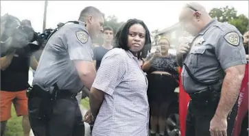  ?? Julia Wall News & Observer ?? IN DURHAM, N.C., Takiyah Fatima Thompson is arrested Tuesday in connection with the toppling of a Confederat­e soldier monument. Some state and local laws prohibit the removal of historical memorials.