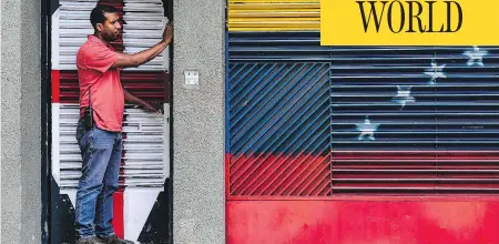  ?? RONALDO SCHEMIDT / AFP / GETTY IMAGES ?? A man stands at the house of opposition leader Leopoldo Lopez in Caracas after he was taken away by the Venezuelan intelligen­ce service.