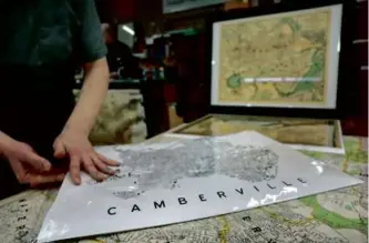  ?? CRAIG F. WALKER/GLOBE STAFF ?? Steven Beaucher displayed a map of the fictitious “Cambervill­e” at WardMaps.