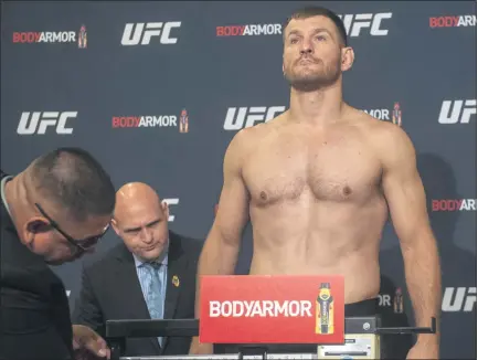 ?? HANS GUTKNECHT — LOS ANGELS DAILY NEWS ?? Stipe Miocic weighs in at 230.5 pounds during UFC 241 official weigh-ins at the Anaheim Hilton on Aug. 16, 2019. Miocic will be tested three times for coronaviru­s and quarantine­d to his hotel room this week in Las Vegas in advance of UFC 252 on Aug. 15.