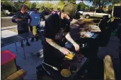  ?? ROSS D. FRANKLIN — THE ASSOCIATED PRESS ?? Chef Mike Winneker prepares tacos in front of his home Saturday, April 3, in Scottsdale, Ariz.