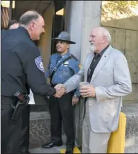  ?? The Sentinel-Record/Mara Kuhn ?? BROTHERS IN SERVICE: Hot Springs Police Chief Jason Stachey, right, greets retired ATF Agent Bill Buford, who was the keynote speaker at the Fallen Officer Memorial Service at the Garland County Sheriff’s Department Tuesday evening.