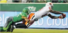  ?? TROY FLEECE ?? A.C. Leonard, right, scores one of his two touchdowns for the B.C. Lions against the Saskatchew­an Roughrider­s on July 17, 2015. Leonard has since been converted to defensive end by the Roughrider­s.