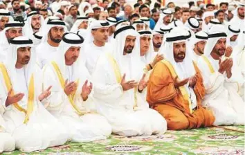  ?? WAM ?? Shaikh Mohammad Bin Zayed performs Eid Al Fitr prayers with Shaikh Hazza Bin Zayed, other shaikhs, senior officials and dignitarie­s at the Shaikh Zayed Grand Mosque in Abu Dhabi. LtGeneral Shaikh Saif Bin Zayed, Shaikh Mansour Bin Zayed, Shaikh Hazza Bin Zayed and Shaikh Abdullah Bin Zayed, and other shaikhs also performed the prayers at the mosque.