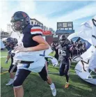  ?? HELEN COMER/THE DAILY NEWS JOURNAL ?? Nashville Christian takes the field before the Bluecross Bowl Division II-A Championsh­ip game against
Friendship Christian at Finley Stadium, in Chattanoog­a on Dec. 1.