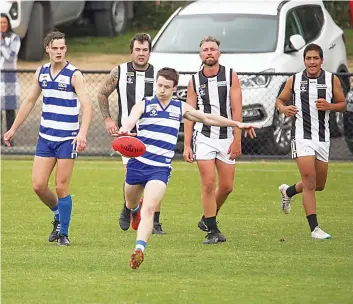  ?? ?? Neerim’s Adam White kicks towards goal in the reserves match against Poowong.