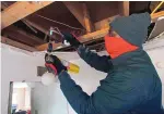  ?? ADOLPHE PIERRE-LOUIS/JOURNAL ?? Cornelius Lewis, owner of Korco Plumbing Services, repairs a water pipe that had frozen, thawed and started to leak above a bathroom in a foothills home earlier this week.