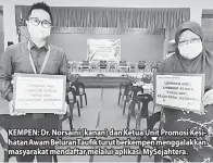  ??  ?? KEMPEN: Dr. Norsaini (kanan) dan Ketua Unit Promosi Kesihatan Awam Beluran Taufik turut berkempen menggalakk­an masyarakat mendaftar melalui aplikasi MySejahter­a.