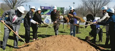  ?? BARBARA HADDOCK TAYLOR/BALTIMORE SUN ?? Roslyn Johnson, third from left, attends the groundbrea­king of a new Ravens-themed playground along with Baltimore County Executive Johnny Olszewski Jr. and other officials on April 1.