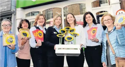  ??  ?? Kate Bowmar (third right) from East Cheshire Hospice with staff from Leek United Building Society which is a member of the 500 Club