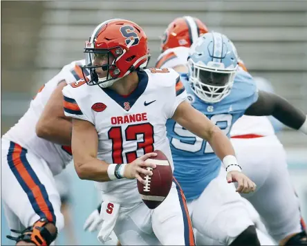  ?? ROBERT WILLETT/THE NEWS & OBSERVER VIA AP, POOL, FILE ?? Syracuse quarterbac­k Tommy Devito (13) scrambles to avoid North Carolina defender Jahlil Taylor (52) in first half of an NCAA college football game in Chapel Hill, N.C., in this Saturday, Sept. 12, 2020, file photo. Syracuse success will depend on a defense that finished 112th overall in 2020, and an offense that struggled behind two-year starter Tommy Devito, who missed much of last season with an injury.