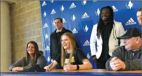  ?? NWA Democrat-Gazette/FLIP PUTTHOFF ?? Skylurr Patrick (center) laughs with classmates during her signing ceremony Wednesday at Rogers High School. Patrick will play soccer at Purdue.