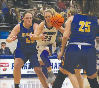  ?? Siandhara Bonnet/News-Times ?? Splitting the defense: In this file photo, Parkers Chapel’s Taylor Fortune tries to drive past two defenders during a game against Spring Hill during the 2019-20 season. The Lady Trojans will be hosting a semifinal game in the district tournament on Wednesday.