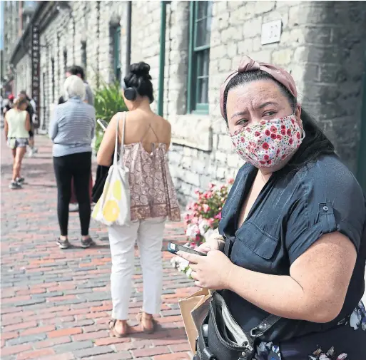  ?? RICHARD LAUTENS TORONTO STAR ?? Isobel Medel waits patiently in an hour-long lineup in the Distillery District on Monday. Only half the typical number of voting stations were in use for the election.