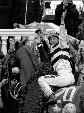  ?? John Minchillo The Associated Press ?? Flavien Prat celebrates after riding Country House to victory in the 145th running of the Kentucky Derby on Saturday at Churchill Downs in Louisville, Ky.