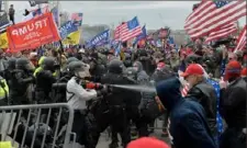  ?? Joseph Prezioso/AFP via Getty Images ?? In this Jan. 6, 2021, photo, Trump supporters clash with police and security forces as they try to storm the Capitol. Four people who marched with the Oath Keepers militia into the Capitol were convicted on Monday.