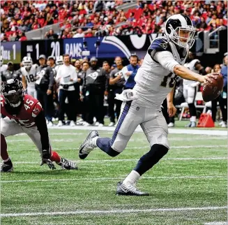  ?? CURTIS COMPTON / CCOMPTON@AJC.COM ?? Rams quarterbac­k Jared Goff gets past Falcons linebacker Deion Jones for a touchdown to take a 27-3 lead during the second half Sunday at Mercedes-Benz Stadium.