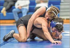  ?? Courtney Couey, Ringgold Tiger Shots ?? Ringgold’s Nolan Rohrer tries to flip over Lafayette’s Jacob Hamilton during a 113-pound match Thursday in Ringgold. Rohrer won the bout, 7-6, but the Ramblers won the dual, 42-39.
