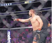  ?? JOHN LOCHER/ASSOCIATED PRESS ?? Khabib Nurmagomed­ov points to a member of Conor McGregor’s entourage. Seconds later, Nurmagomed­ov vaulted out of the Octagon and started swinging.