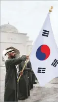  ?? ?? Left: The South Korean flag is flown during the official reception for President Yoon at Qasr Al Watan.