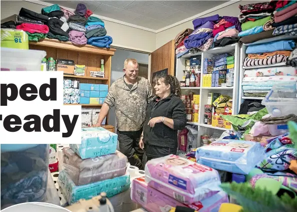  ??  ?? Maarty and Shenah Lintern, above, are prepped and ready for almost anything, and, left, they’ve made sure their children Simeon and Skylah have learnt how to make shelters, fix wounds and safely start a campfire.