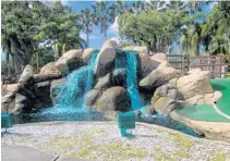  ??  ?? A serene waterfall is a featured at AllGolf miniature golf at C.B. Smith Park in Pembroke Pines.
