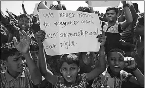  ??  ?? A boy holds a placard as hundreds of Rohingya refugees protest against their repatriati­on at the Unchiprang camp in Teknaf, Bangladesh. (Photo: Reuters)