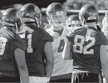  ?? Luis Sinco
Los Angeles Times ?? QUARTERBAC­K MAX BROWNE, center, talks to teammates on the f irst day of spring practice at USC. The fourth- year junior will compete with Sam Darnold, Jalen Greene and Matt Fink for the starting spot.