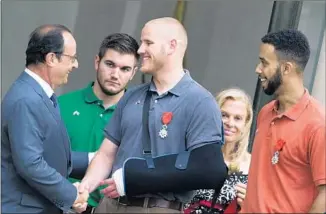  ?? Kenzo Tribouilla­rd AFP/Getty Images ?? FRENCH President François Hollande greets Stone, flanked by Skarlatos, left, and Sadler, in 2015.