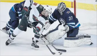  ?? CANADIAN PRESS FILE PHOTO ?? Minnesota Wild’s Jordan Greenway can’t get the puck past Jets’ goaltender Connor Hellebuyck during the first period of Game 5 in Winnipeg on April 20.