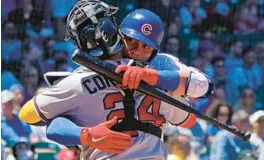  ?? NAM Y. HUH/AP ?? Cubs catcher Willson Contreras, right, hugs younger brother William of the Braves during the first inning Saturday at Wrigley Field.