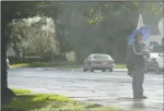  ?? BEA AHBECK/NEWS-SENTINEL ?? A mail carrier carries an umbrella while working during a rainy day in Lodi on Thursday.